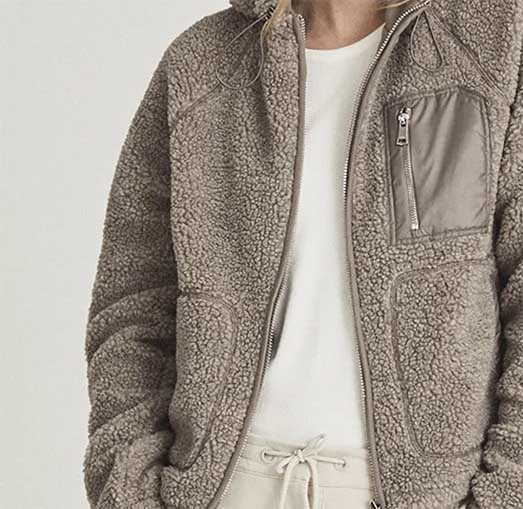 Stone teddy fleece hoodie cover over white t and track pant.